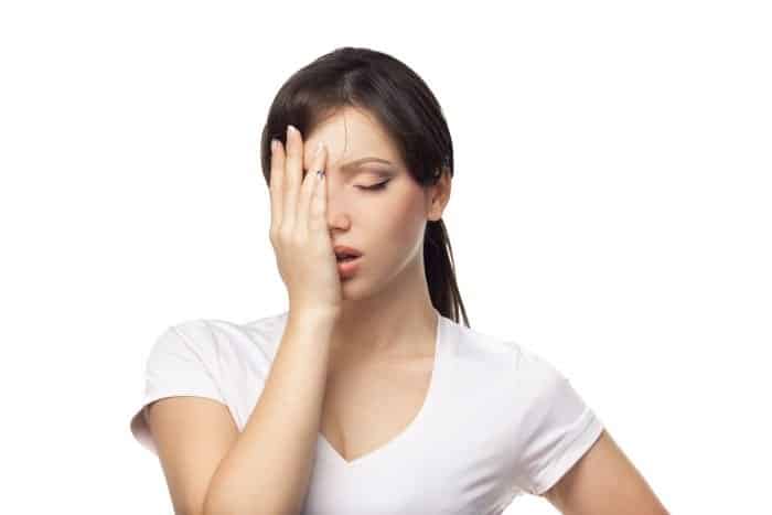 A frustrated woman in a white t-shirt