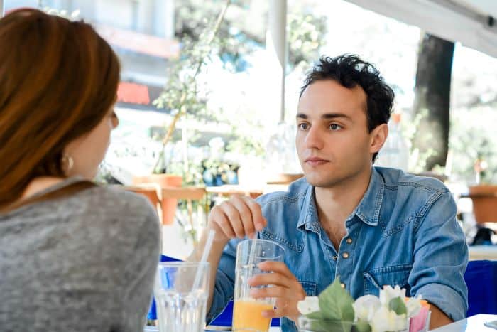 Man and woman talking on a date over coffee